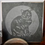 D24. Stone cat plaque.